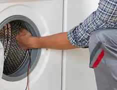 Dryer repair technician diagnosing and servicing a clothes dryer in Akron, OH