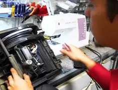 Vacuum repair technician servicing internal components on a workbench in Akron, OH