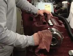 Vacuum repair technician cleaning and servicing a vacuum motor in Akron, OH